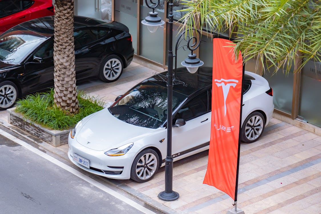 Modern electric sedan parked in an urban setting, blending in like a normal car.