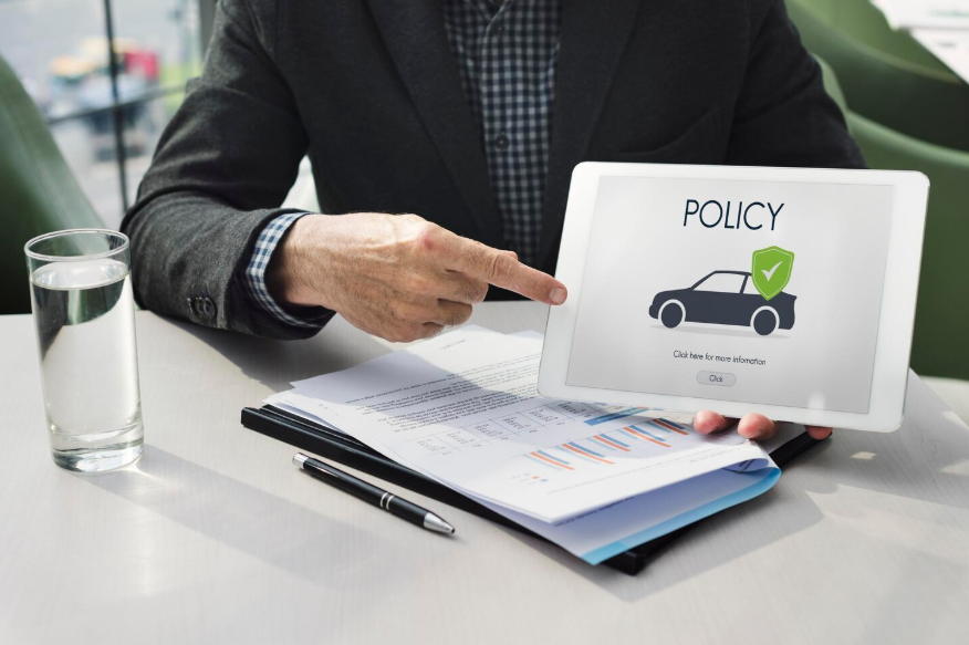 Extended car warranty policy explained on tablet during dealership discussion.