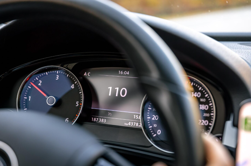 Car dashboard showing odometer reading highlighting low mileage used car listings.