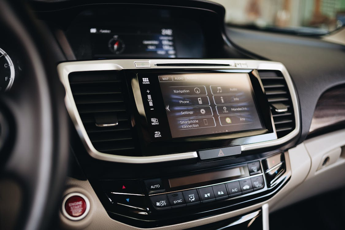 Car dashboard with touchscreen replacing traditional physical buttons.
