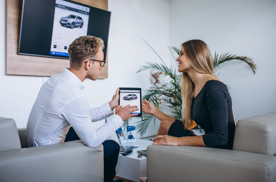 Buyer reviewing a used car listing, discussing pricing details and potential hidden costs.
